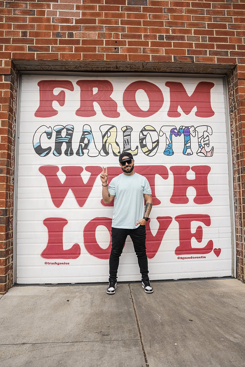Carlos Soto in front of the "From Charlotte With Love" mural in Charlotte, NC
